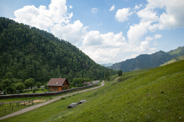 A house in a village in a picturesque mountain valley in summer.
