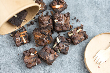 Chocolate brownie with sliced almond nuts and chocolate chips toppings. Top view