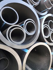 The stack of HDPE (high density polyethylene) pipes shot close up inside the warehouse