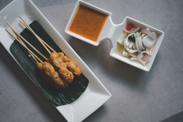 Moo Satay grilled pork served with peanut sauce or sweet and sour sauce - Asian food Concept style