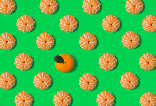 Tangerines on the green background. Flat lay. Pattern. Top view.