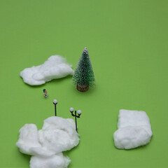 Winter idyll with pine tree, snow, street lights with strong shades on a green background with copy...