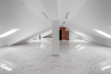 Spacious empty hollow attic with tiled floor