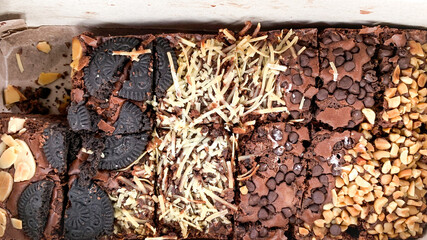 close up of chocolate baked brownies with various toppings.
