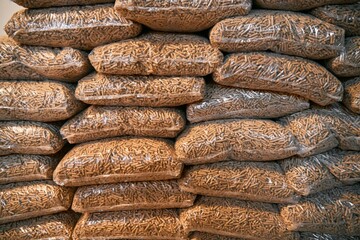 A massive stack of wooden pellets. Eco fuel for house heating. Sustainable and renewable energy for the better future concept.