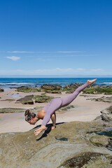 Fototapeta na wymiar flying splits yoga on the beach