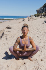 prayer squat pose malasana yoga on the beach