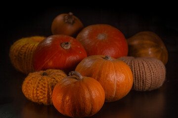 Yellow-orange pumpkins on a black background the concept of Halloween and the autumn harvest of pumpkin close-up copyspace from above