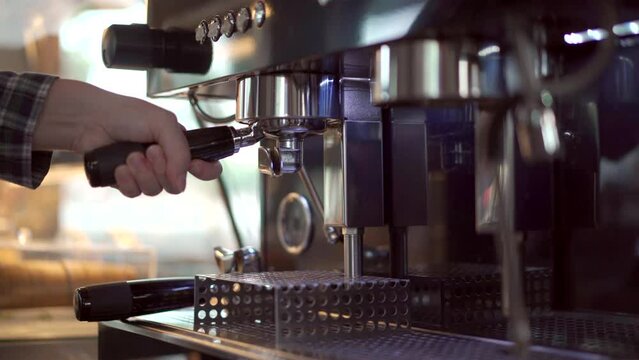 B-roll footage showing barista making an espresso coffee from the professional espresso machine in coffee shop. 