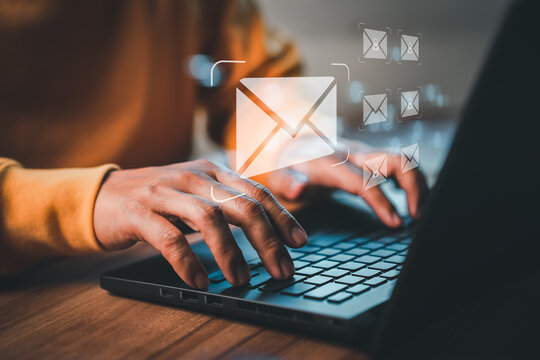 Freelancer's hand using computer laptop and sending online message with email icon, email marketing concept, send email or newsletter, internet network working online.
