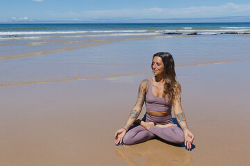 Fototapeta na wymiar person meditating on the beach