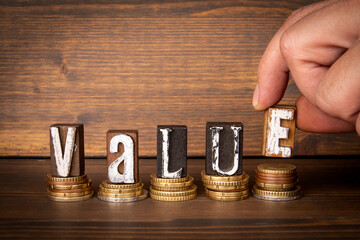 Value concept. Text and money on wood texture background