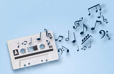 audio tape and flying musical notes on blue isolated background