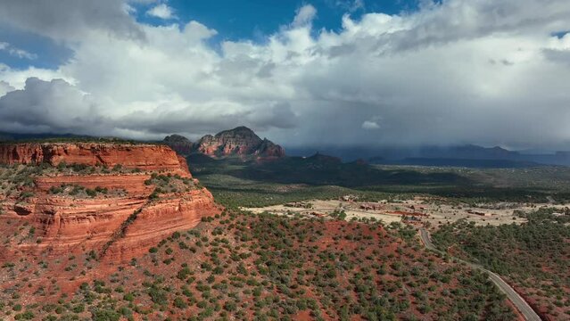White Clouds Over Sedona Red Cliffs And Forest Desert In Arizona, USA. Aerial Wide Shot