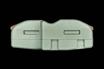 Compact splicing connector isolated on black background.