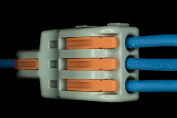 Compact splicing connector isolated on black background.