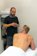 Physiotherapist talking to client before physiotherapy massage