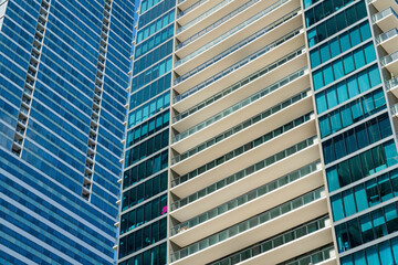 Low angle view of two condominium buildings with glass exterior at Miami, Florida