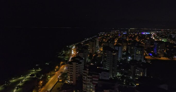 Antalya Turkey Aerial v58 low flyover bustling lara street along the coastline capturing illuminated downtown cityscape of &ccedil;ağlayan neighborhood at night - Shot with Mavic 3 Cine - July 2022