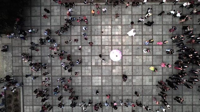 aerial view of a traditional dance with mannequins in oaxaca city at sunset