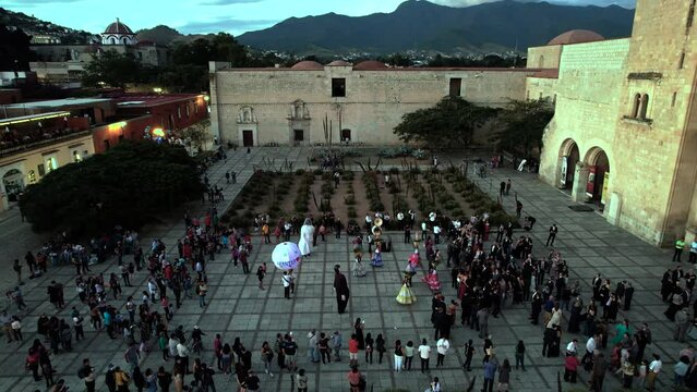 aerial view of a traditional dance with air balloons in front of the church of santo domingo in oaxaca city