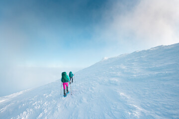 two girls climb the mountain.