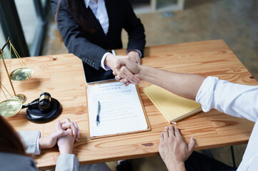 Law, consultation, agreement, contract, lawyer or  attorney shakes hands to agree on the client's...