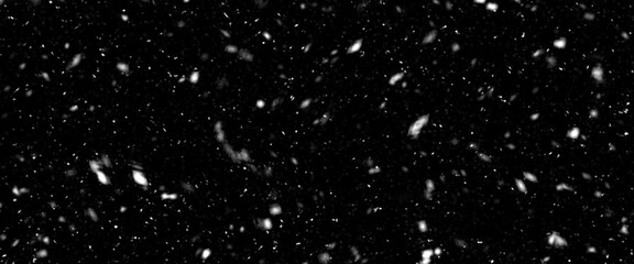 Different realistic falling snow or snowflakes. Falling snow isolated on black background. Winter snowfall illustration. Bokeh lights on black background, flying snowflakes in the air. Snow at night.