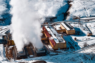 Aerial view to geothermal power plant in mountain. Clean renewable green energy in Kamchatka. - 550551091