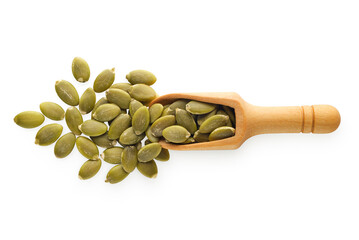 Dried peeled pumpkin seeds in a wooden scoop