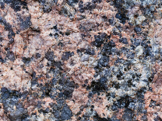 Granite texture. Natural pink granite with a grainy pattern. Stone background. Solid rough surface...