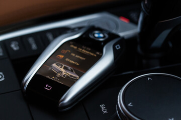 MOSCOW, RUSSIA - FEBRUARY 05, 2022. BMW smart key close up view. Modern BMW wireless car key. Translation: "Opened. Connected."