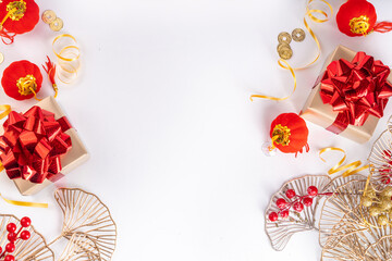 Chinese New Year on white background. Lunar New Year greeting card with traditional festival decoration - ginkgo biloba, golden twigs, gift boxes, red berries, gift envelopes, coins, chinese lanterns