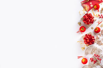 Chinese New Year on white background. Lunar New Year greeting card with traditional festival decoration - ginkgo biloba, golden twigs, gift boxes, red berries, gift envelopes, coins, chinese lanterns