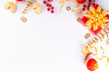 Chinese New Year on white background. Lunar New Year greeting card with traditional festival decoration - ginkgo biloba, golden twigs, gift boxes, red berries, gift envelopes, coins, chinese lanterns