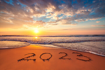 Happy New Year 2023 ocean sunrise on the beach shore concept - obrazy, fototapety, plakaty