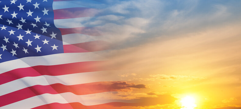 United States of America flag on sky at sunset or sunrise background. Independence day, Memorial day, Veterans day. Banner.
