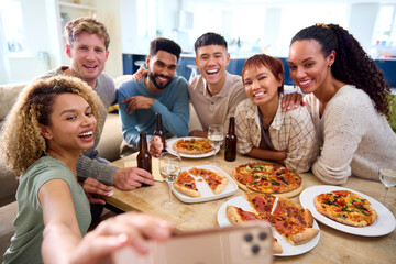 Friends Taking Selfie On Phone Having Fun At Home In Kitchen Eating Homemade Pizzas