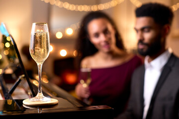Couple Around Piano Celebrating At Christmas Or New Year Party Together