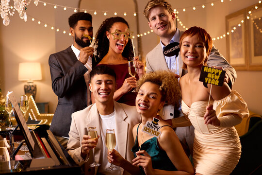 Portrait Of Friends Posing For Selfie Around Piano Celebrating At New Year Party Together