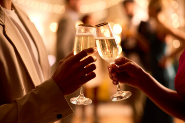 Close Up Of Couple At Party Making Champagne Toast Together