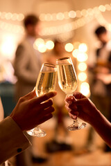 Close Up Of Couple At Party Making Champagne Toast Together