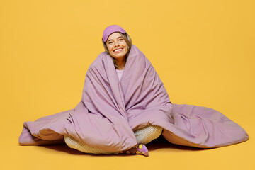 Full body young smiling happy fun woman she wears purple pyjamas jam sleep eye mask rest relax at...