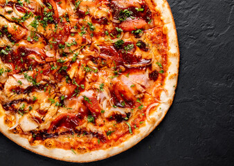Pizza with chicken and barbeque sauce. Italian pizza on Dark grey black slate background