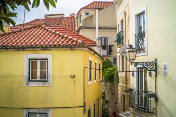 Obraz premium historic buildings of the old town of lisbon. Old colorful buildings, narrow streets, historic churches. Cloudy day
