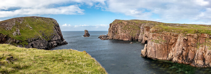 The cliffs and sea stacks at Port Challa on Tory Island, County Donegal, Ireland © Lukassek
