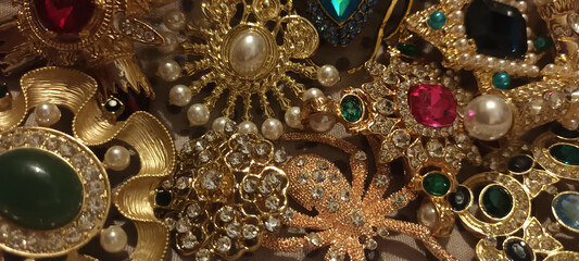 Jewelry vintage at the flea market. Rare things, brooches with stones