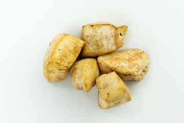 fresh baked chicken cubes on white background top view