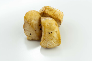 fresh baked chicken cubes on white background