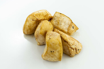 fresh baked chicken cubes on white background top view
